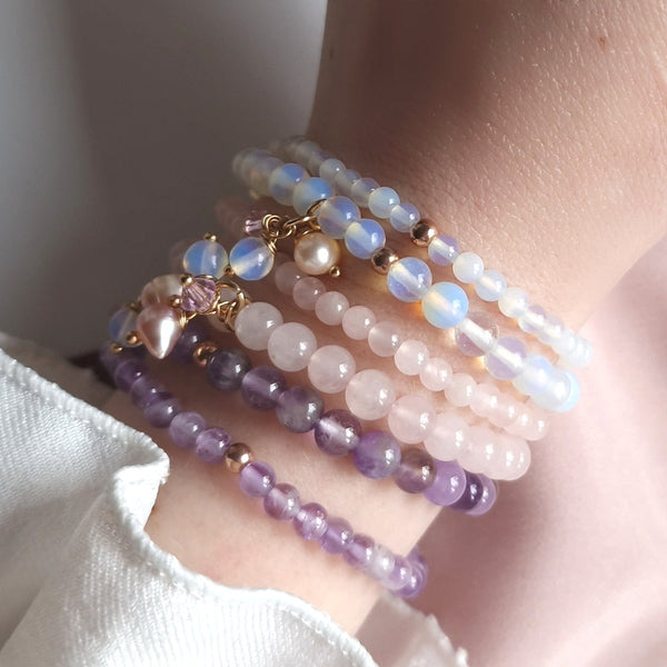 Healing gemstone bracelets with moonstone, rose quartz and amethyst on wrist