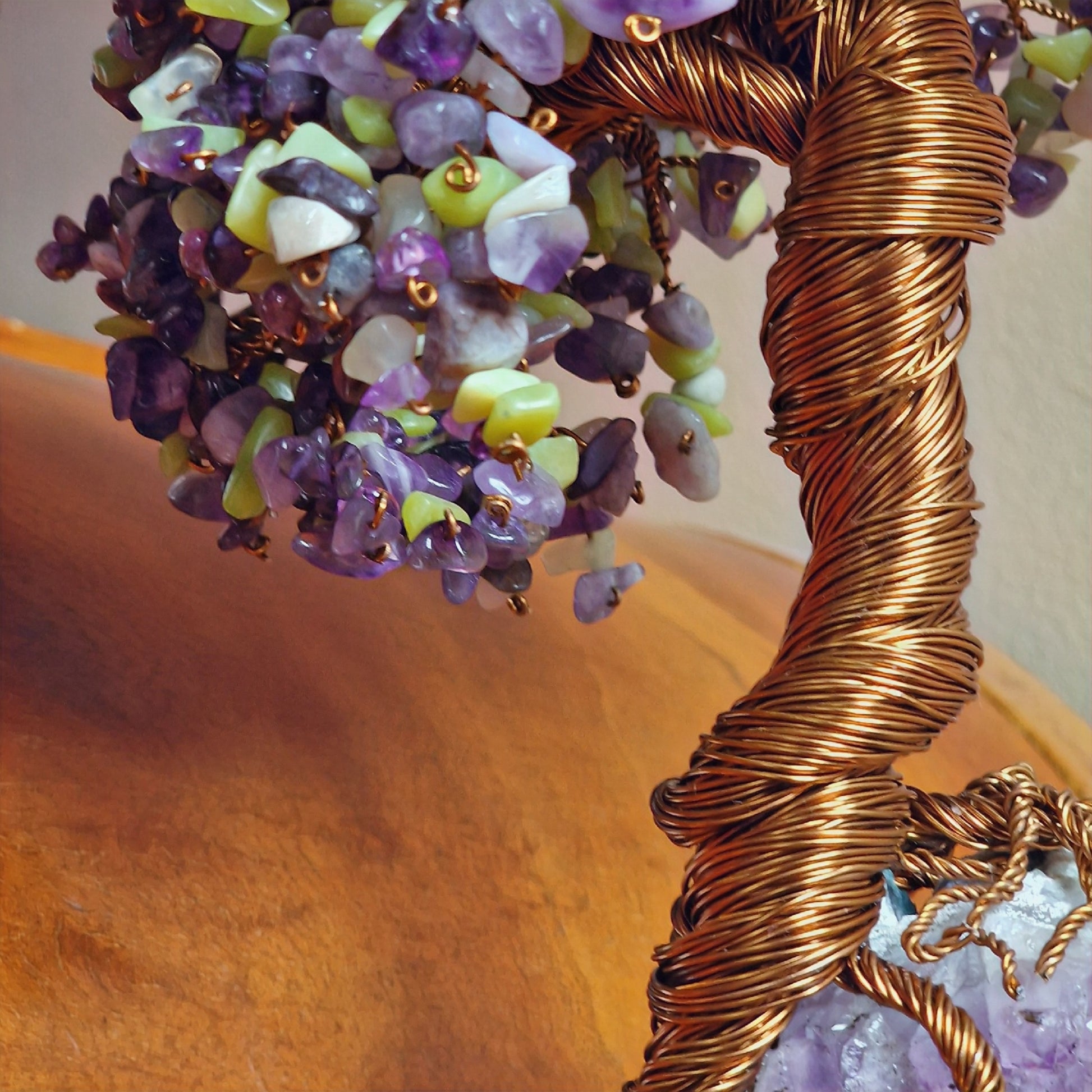 Detailed view of over 1,000 natural Amethyst and Peridot gemstone chips forming the leaves of the Tree of Life sculpture