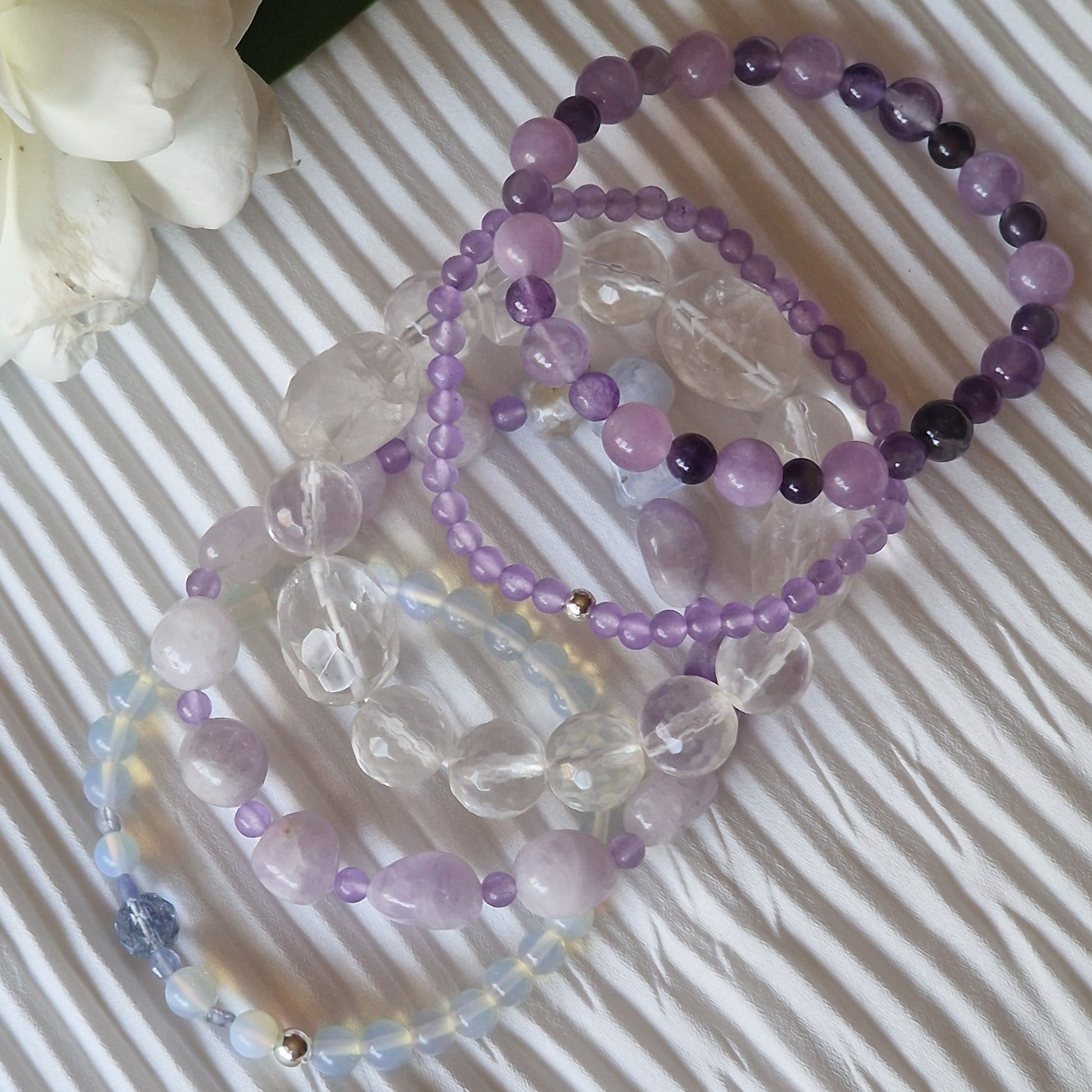 Anremo Azar five‑bracelet set featuring Himalayan quartz, pale lavender jadeite, jadeite & aquamarine mix, moonstone‑topaz‑tanzanite blend, and amethyst harmony bracelets