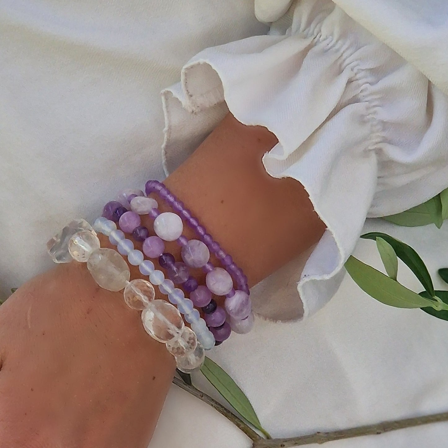 Anremo Azar five‑bracelet set featuring Himalayan quartz, pale lavender jadeite, jadeite & aquamarine mix, moonstone‑topaz‑tanzanite blend, and amethyst harmony bracelets