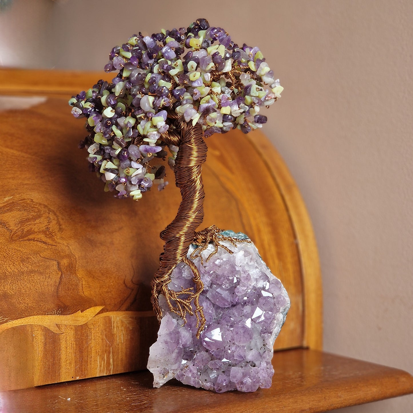 Amethyst and Peridot Crystal Tree of Life displayed in a luxurious, zen-inspired interior decor setting