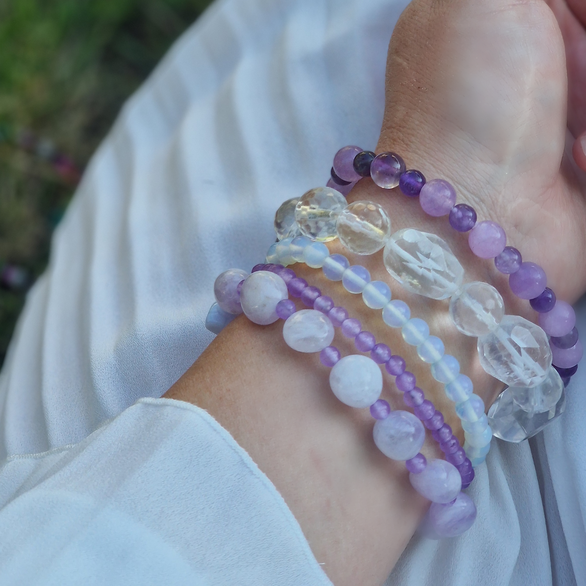 Anremo Azar five‑bracelet set featuring Himalayan quartz, pale lavender jadeite, jadeite & aquamarine mix, moonstone‑topaz‑tanzanite blend, and amethyst harmony bracelets