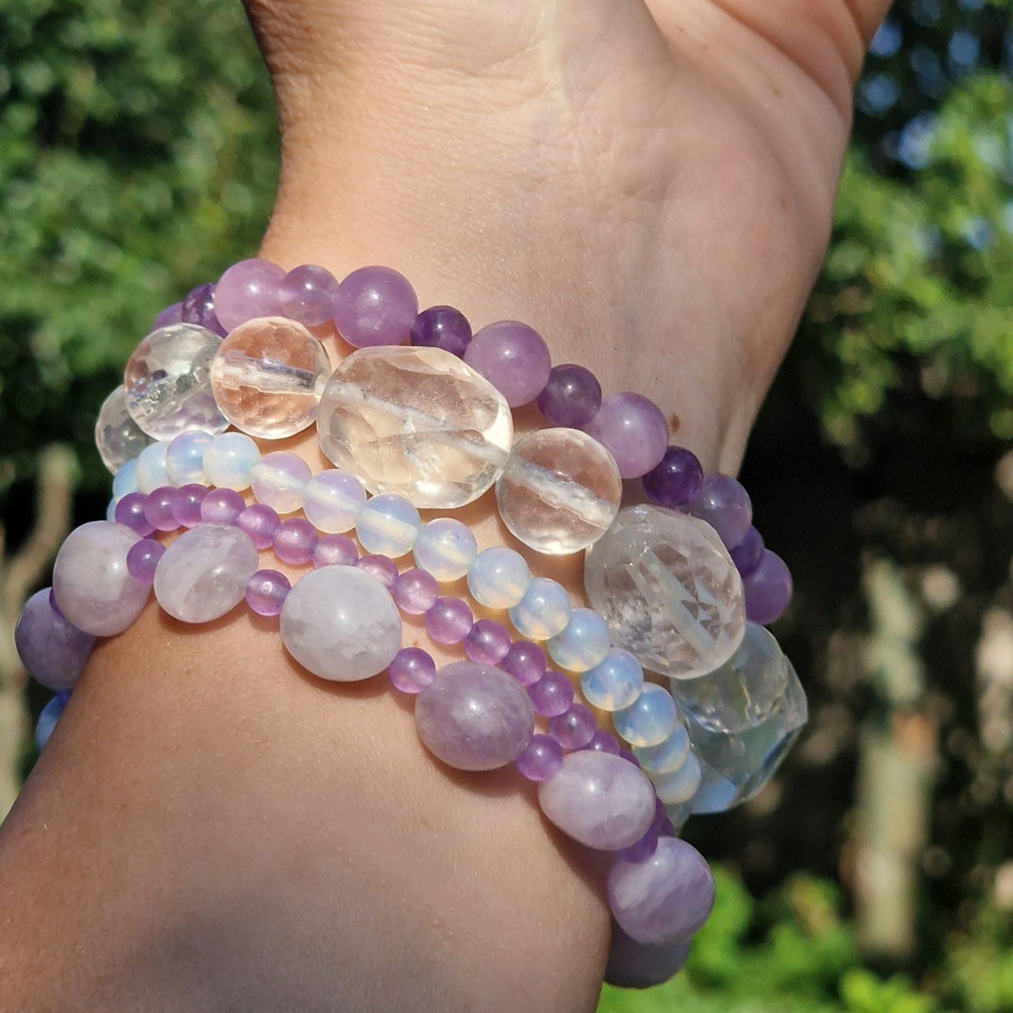 Anremo Azar five‑bracelet set featuring Himalayan quartz, pale lavender jadeite, jadeite & aquamarine mix, moonstone‑topaz‑tanzanite blend, and amethyst harmony bracelets