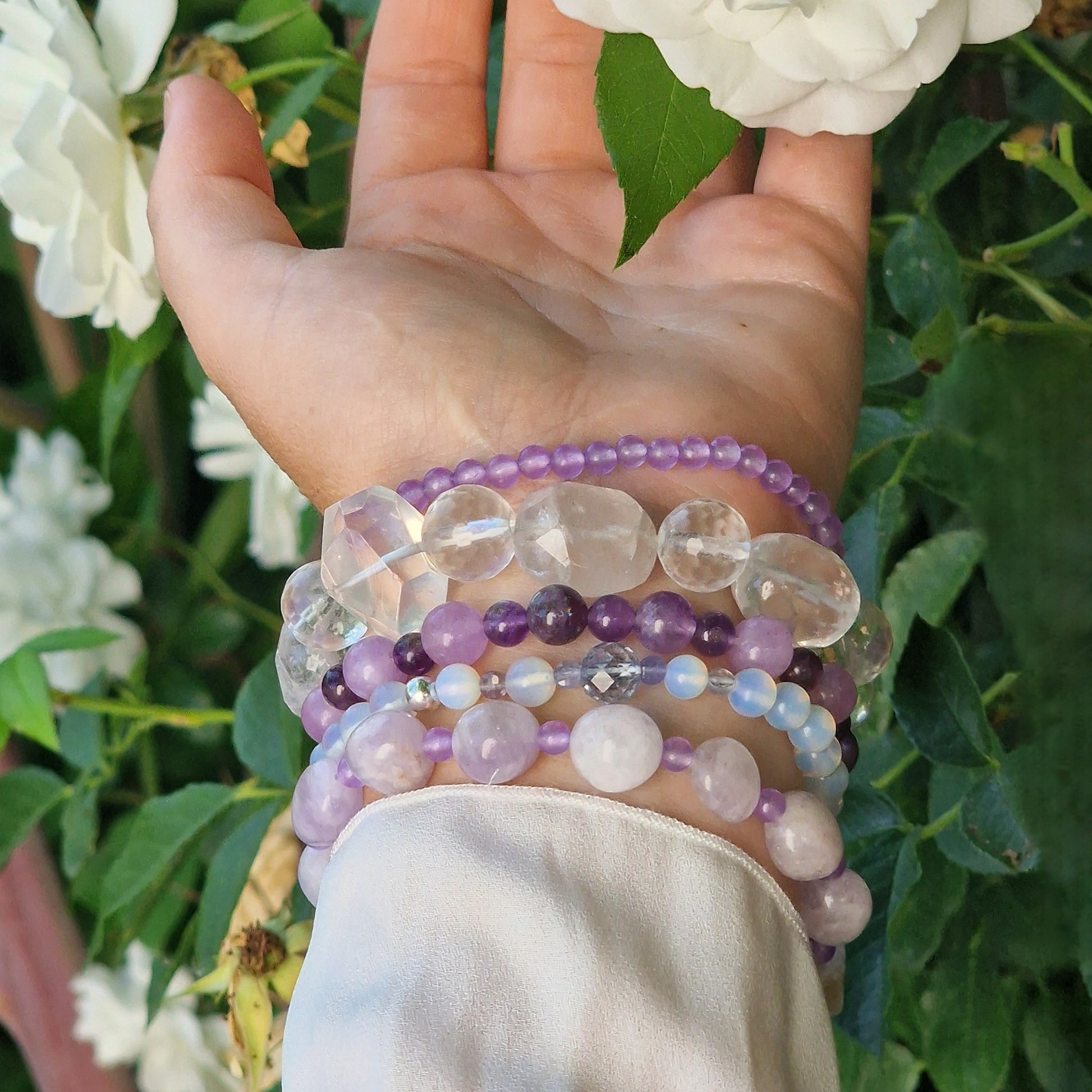 Anremo Azar five‑bracelet set featuring Himalayan quartz, pale lavender jadeite, jadeite & aquamarine mix, moonstone‑topaz‑tanzanite blend, and amethyst harmony bracelets