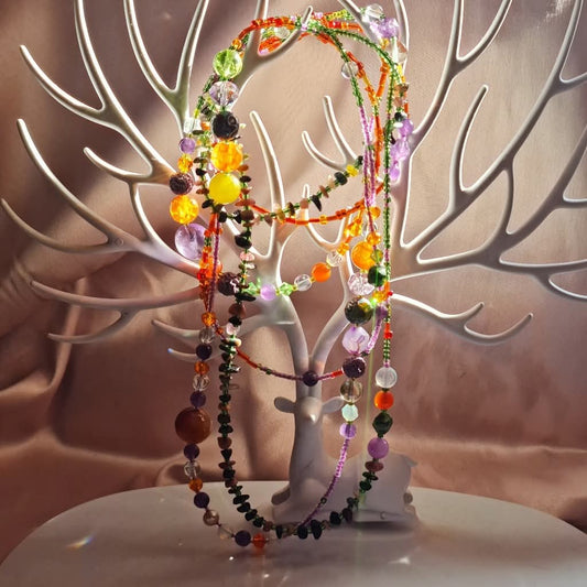 A 188 cm multi-stone wrap necklace draped around a woman’s neck, showcasing agate, amethyst, tourmaline, rose quartz, jadeite, peridot, moonstone, opalite and sunstone beads