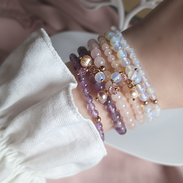 Stack of four natural amethyst bracelets with different bead sizes