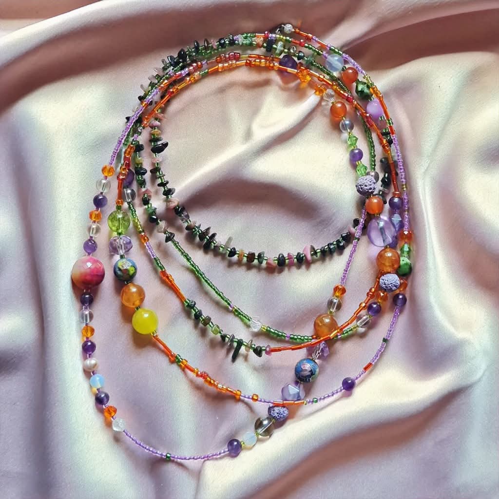 A 188 cm multi-stone wrap necklace draped around a woman’s neck, showcasing agate, amethyst, tourmaline, rose quartz, jadeite, peridot, moonstone, opalite and sunstone beads